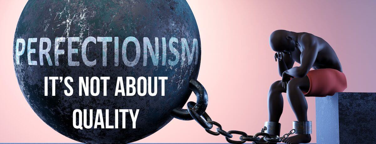 Perfectionism as a heavy weight in life - symbolised by a person in chains attached to a prisoner ball to show that Perfectionism can cause suffering,